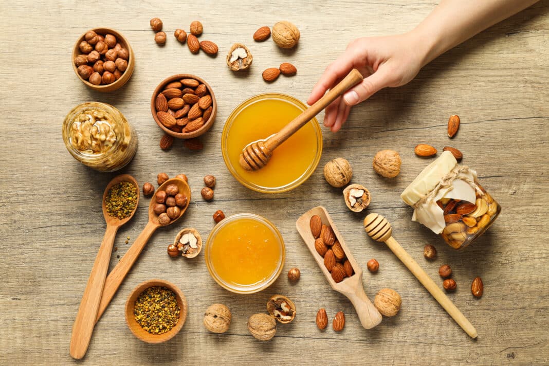 Concept of tasty and sweet food - honey with nuts
