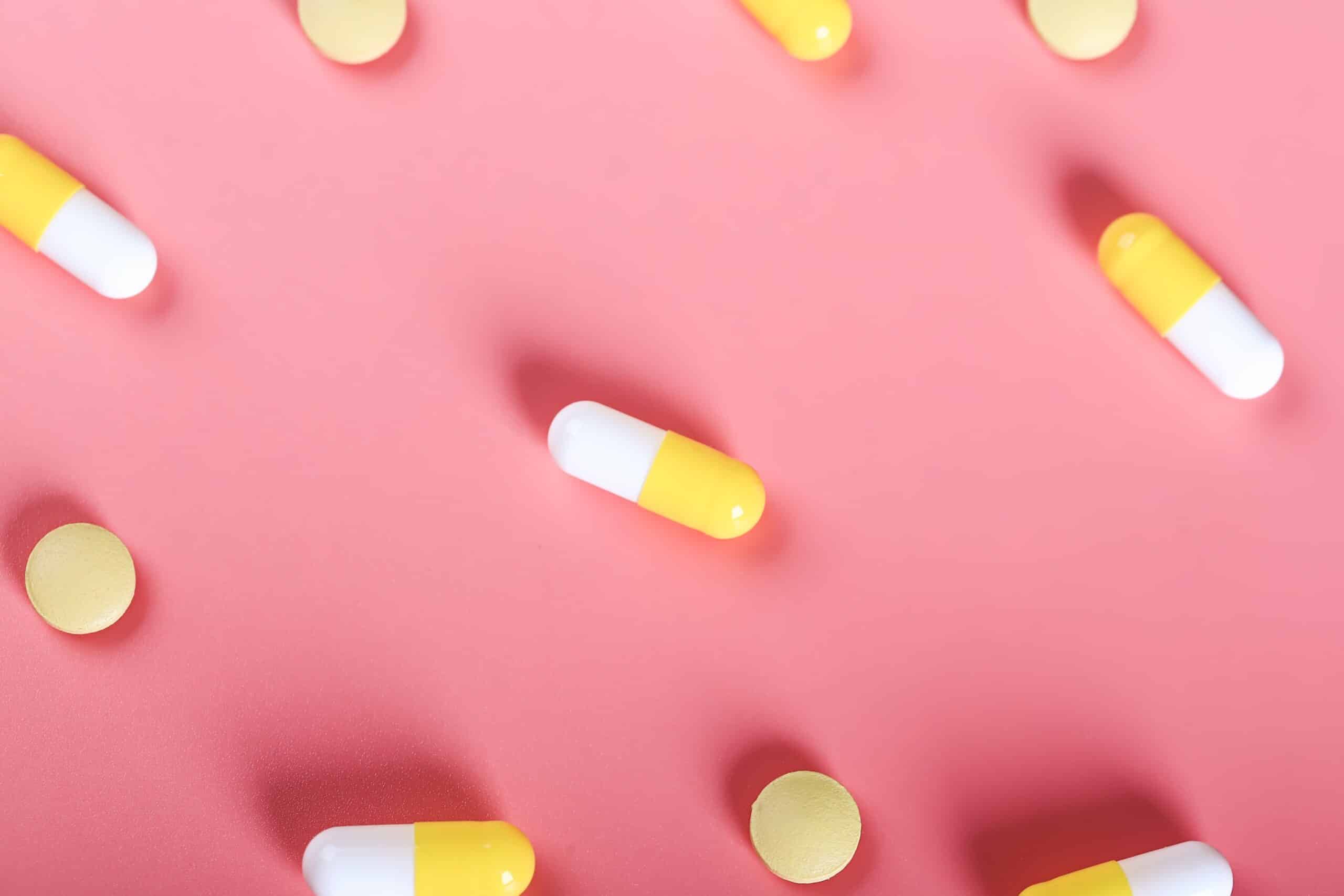 yellow pills pills on a pink background 2022 11 01 00 07 46 utc scaled