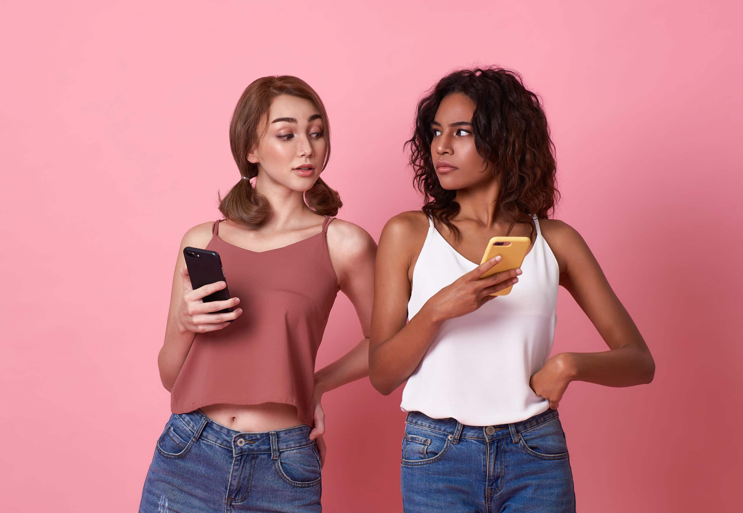 young two women using mobile phone while brunette 2023 04 14 00 05 24 utc scaled