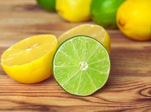 lemons and limes on wooden pad. creative photo.