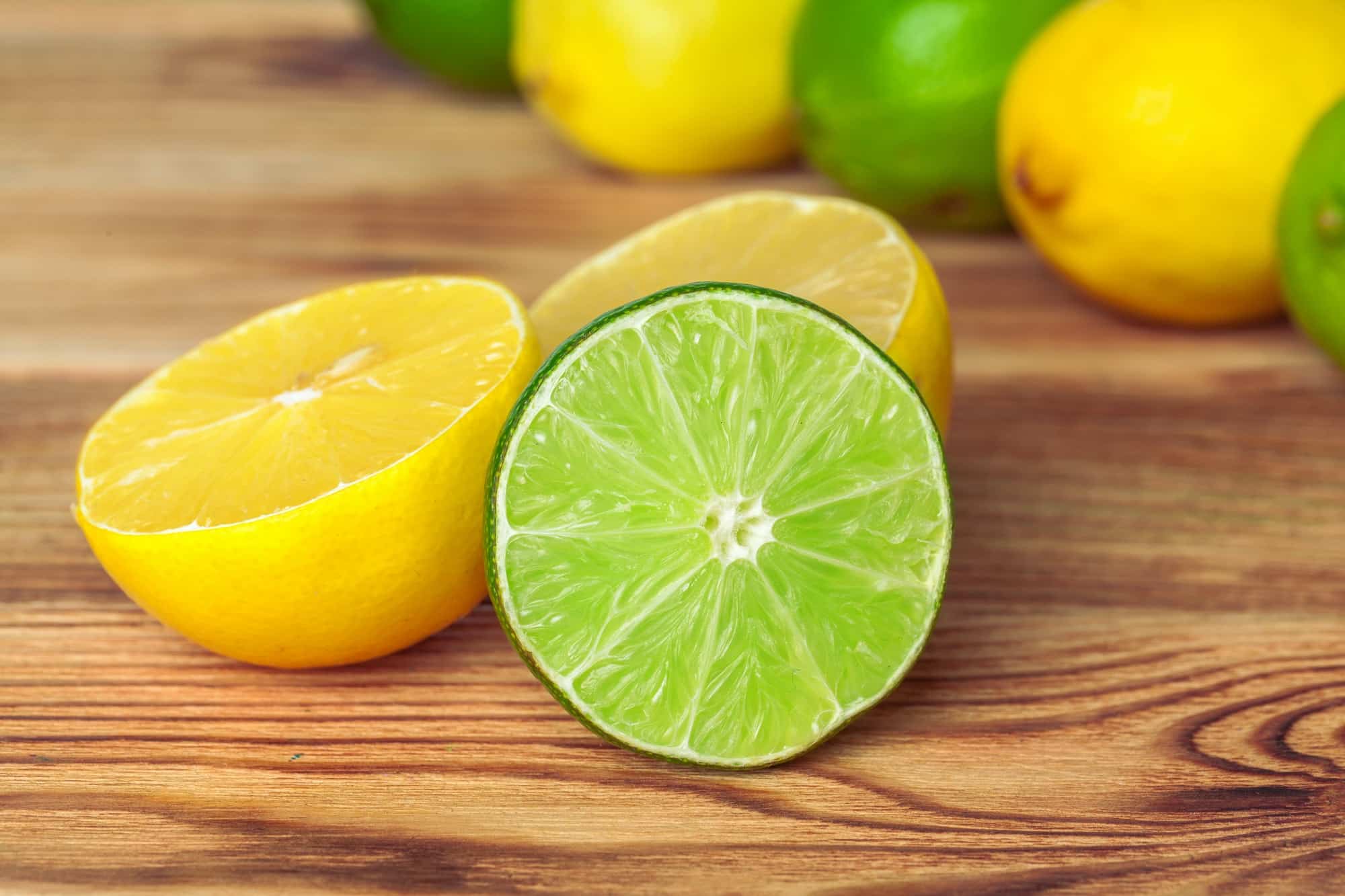 lemons and limes on wooden pad. creative photo.