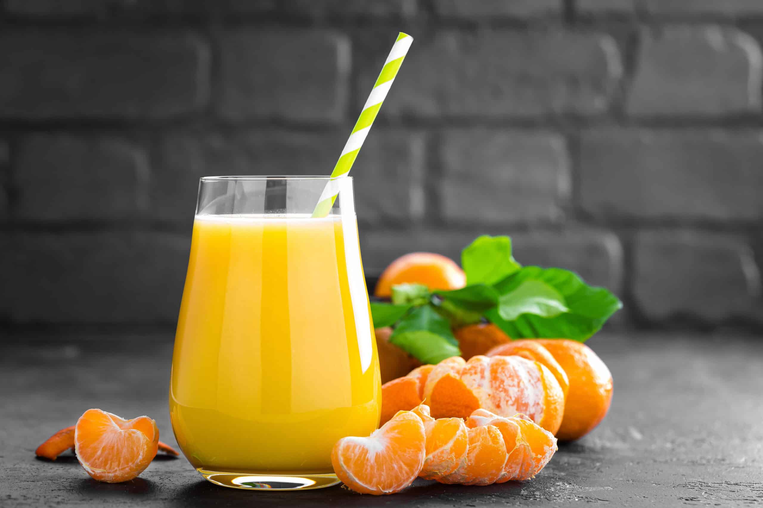Tangerines, peeled tangerines and tangerine juice in glass