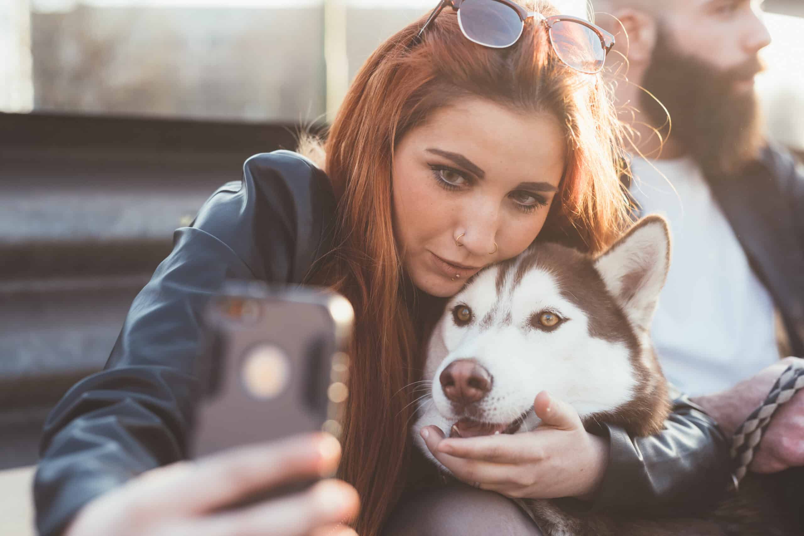 Young woman taking selfie with dog