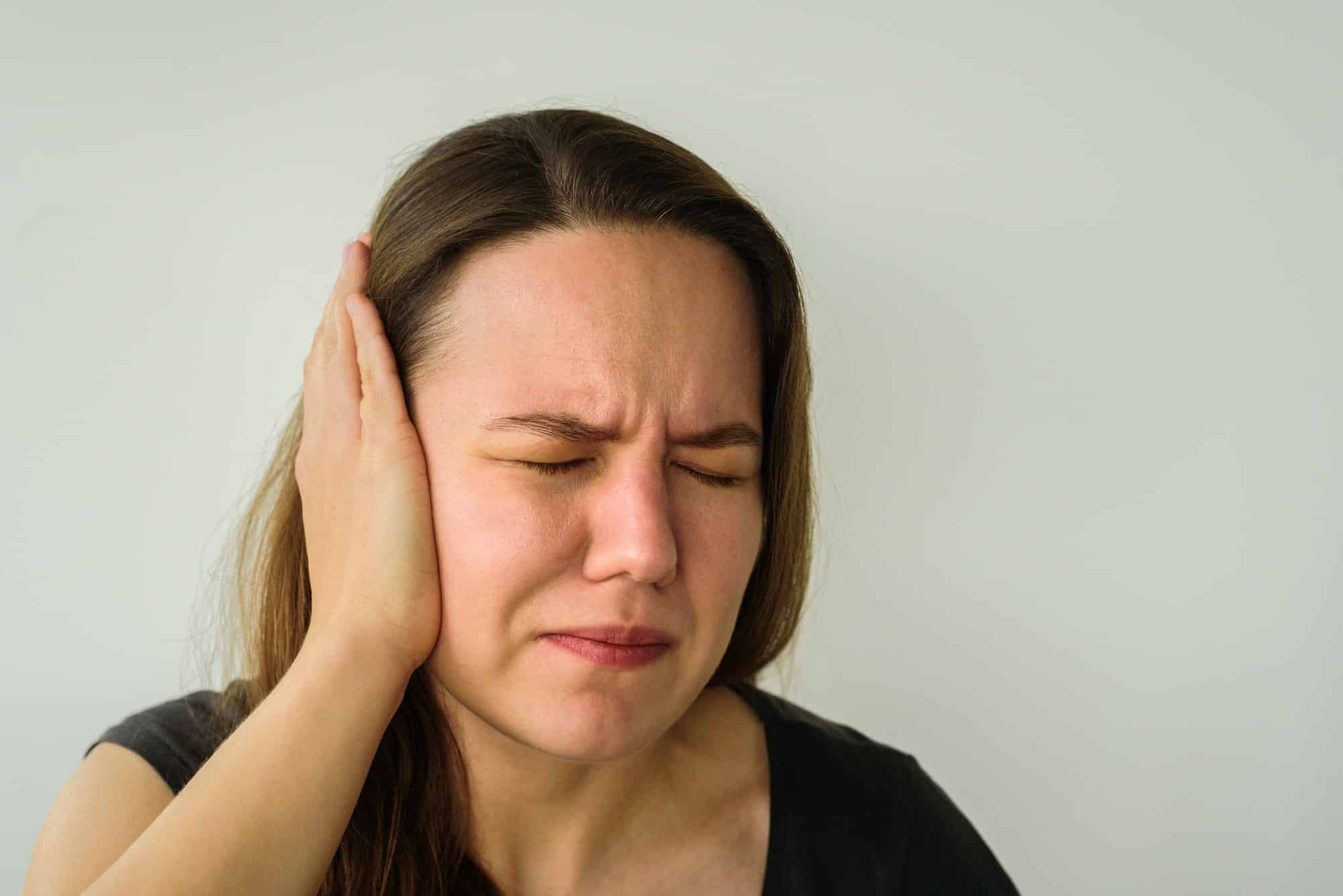 Young woman with ear pain