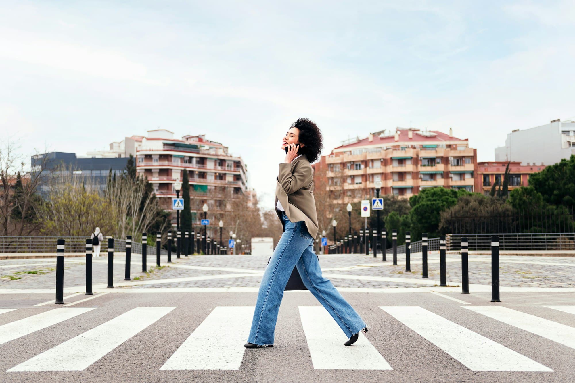 business woman walking talking by mobile phone