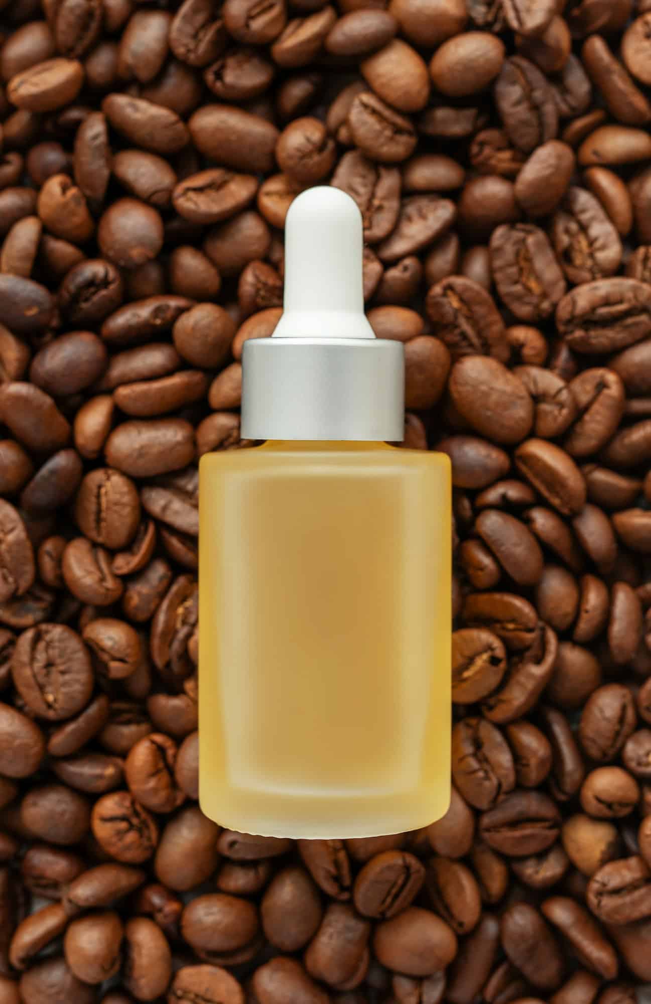 Skincare caffeine eye serum. Product bottle and coffee beans.