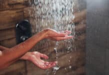 Close up view of hands of woman that taking a shower in spa