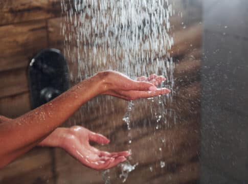 Close up view of hands of woman that taking a shower in spa